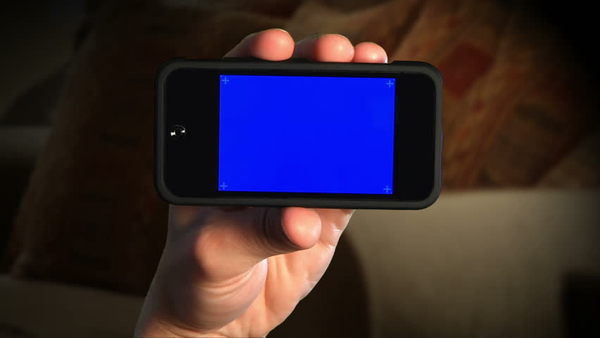 Holding a portable media player.  Blue screen for your custom video content. 