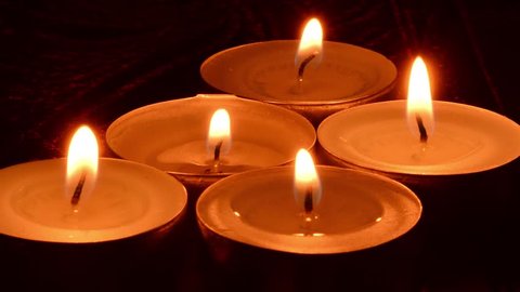 five candles on dark red background