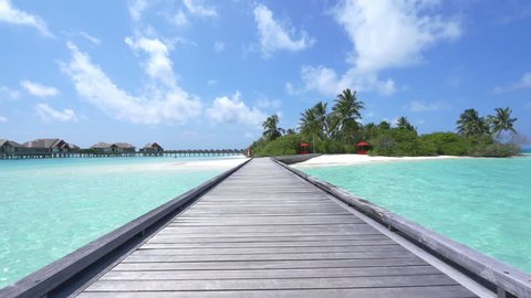 SLOW MOTION: Water villas in front of exotic white sand beach