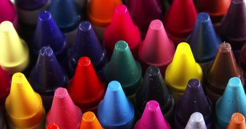 Macro shot of the tips of rotating colorful crayons