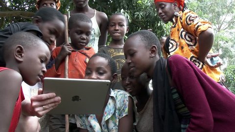 KIGALI, RWANDA JANUARY 2015: African children see a tablet for the first time