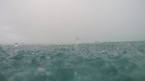 UNDERWATER SLOW MOTION: Heavy raining into the ocean