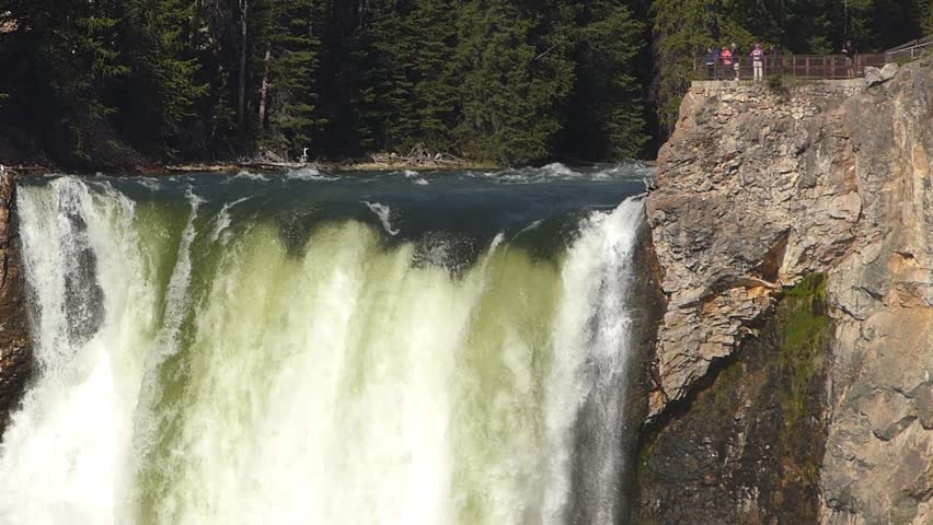 Closeup of Lower Falls with people on a viewing platform in Yellowstone National Park, Wyoming, USA