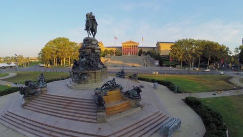 PHILADELPHIA - SEP 02, 2014: Cars ride by road near Statue of George Washington and Philadelphia Museum of Art at evening. Aerial view. George Washington was the first President of the United States.