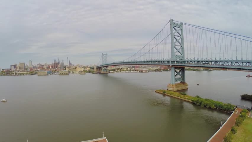 Benjamin Franklin Bridge across Delaware river at autumn cloudy day. Aerial view