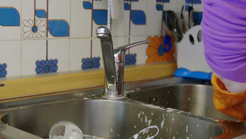 housewife washing dishes: fork, pot, glasses, spoon, cut