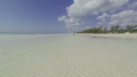 Kid running on beach in the Bahamas