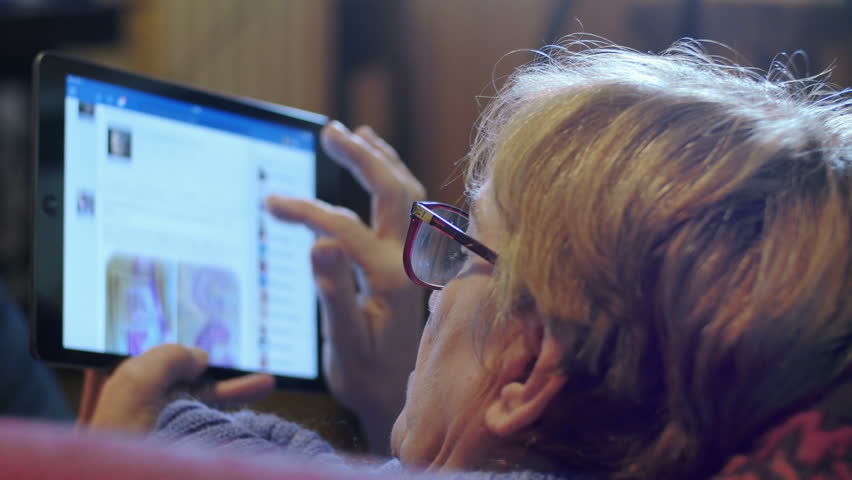 old woman using social networks on tablet computer: facebook, chat, post Royalty-Free Stock Footage #9339791