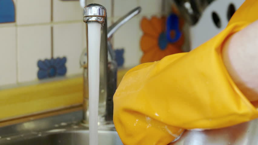 housewife washing dishes by hand: woman with daily home works