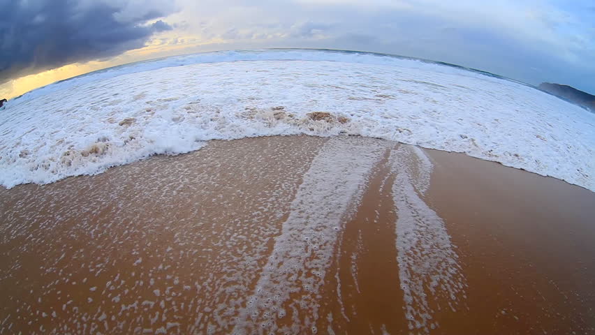 wave crashes onto shore, fish-eye  