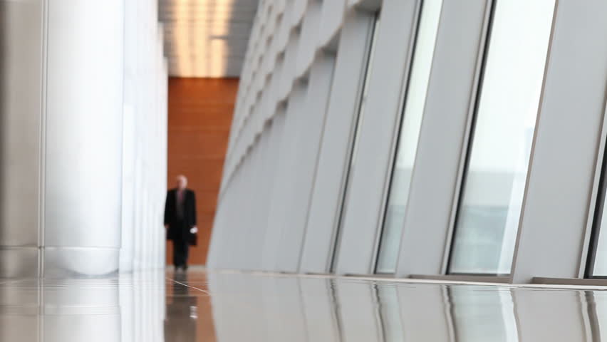 Businessman walk in hall of airport building 