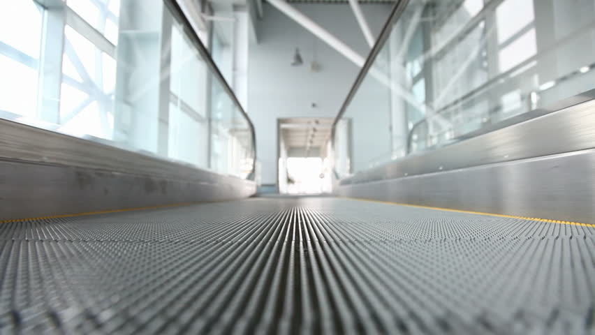 Fast moving steel escalator in public building 
