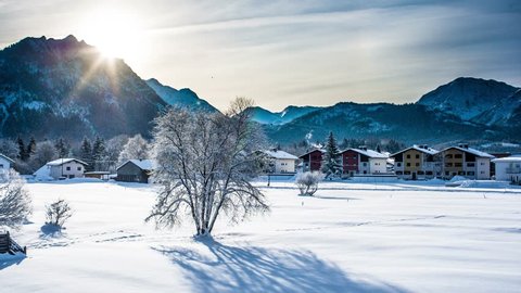Timelapse of Alpine mountain morning, 4K, UHD. Picturesque landscape time lapse of the early winter morning in the small village in the Alps mountains in Austria. Winter travel and holiday concept. Stockvideó