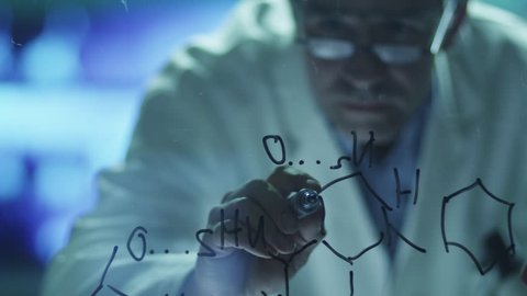 Scientist is Drawing Organic Chemical Formulas on Glass. Shot on RED Cinema Camera in 4K (UHD). Stockvideo
