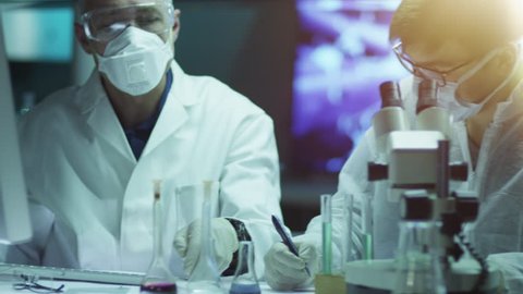 Team of Scientist Does Chemical Researches and Experiments in Laboratory. Shot on RED Cinema Camera in 4K (UHD).