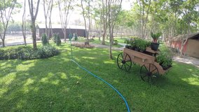 Footage of sprinkler spread water in the garden