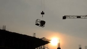 silhouette of crane working for building construction