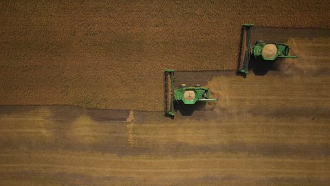 Stock Video Footage aerial view combines harvesting top view