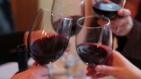 Four People Wine Glass "Cheers" at an expensive restaurant dinner.