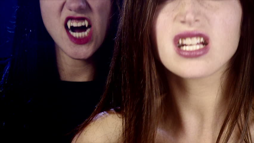 Gorgeous sensual female vampires posing looking camera angry closeup