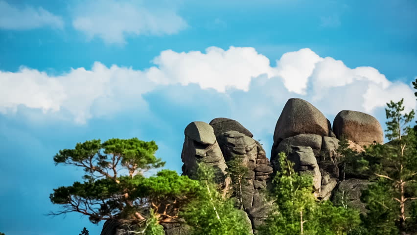 Mountain Landscape, 
Running clouds and mountain silhouette of rocks and trees, TimeLapse