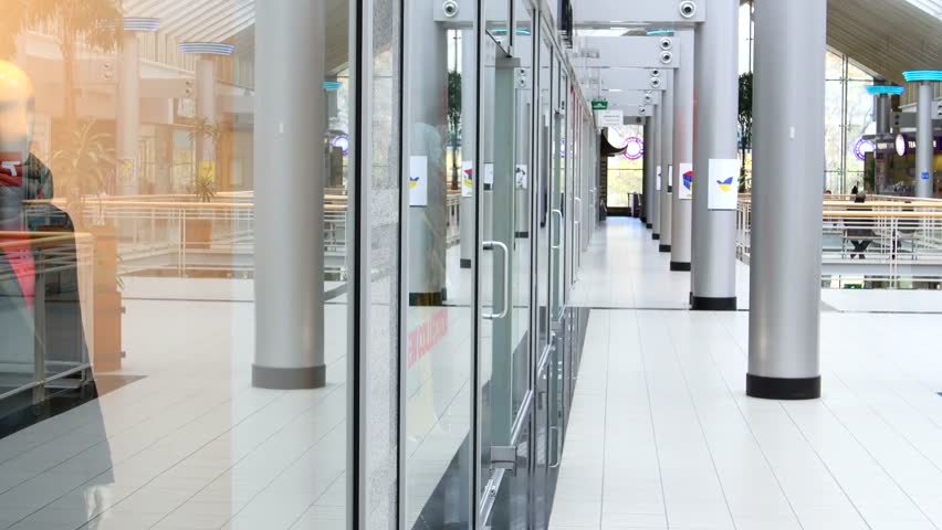 Two beautiful girls with shopping bags suited to showcase at the mall.
