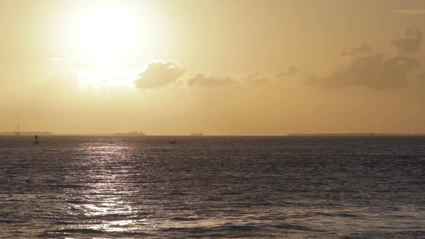 setting sun on the water in the Caribbean, horizon glows