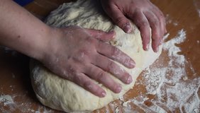 Woman knead dough on the table. HD video