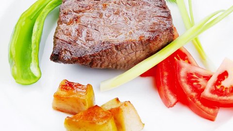 meat food : roasted fillet mignon plate with tomatoes apples and chili pepper over wooden table 1920x1080 intro motion slow hidef hd