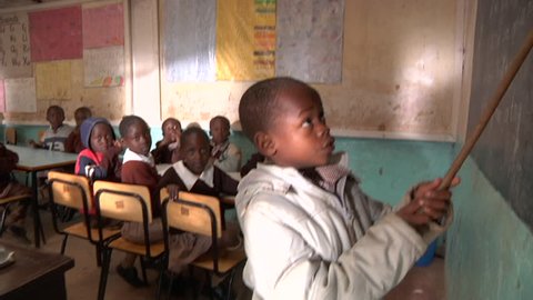 NAIROBI, KENYA - CIRCA JULY 2009: A young Kenyan schoolboy recites English phrases with his classmates. High definition.