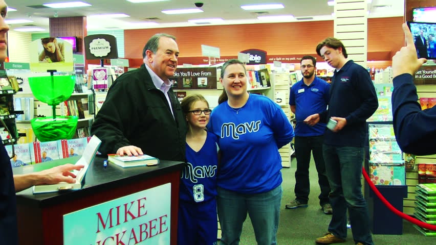 SHREVEPORT, LOUISIANA/USA - FEBRUARY 7, 2015: American politician Mike Huckabee signs fans' copies of his book, 'God, Guns, Grits, and Gravy.' | Shutterstock HD Video #9403508