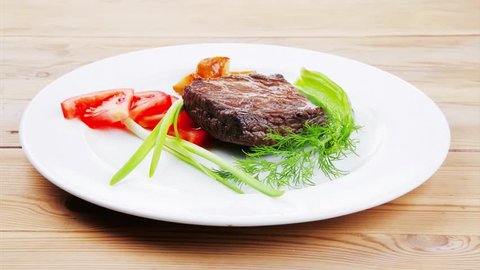 meat food : roasted fillet mignon plate with tomatoes apples and chili pepper over wooden table 1920x1080 intro motion slow hidef hd
