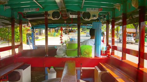 SUKHOTHAI. THAILAND - CIRCA NOV 2013: Riding in an old. empty bus. from a passenger's perspective. with sound.