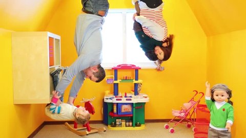 Family of four in children room upside down at inverted house