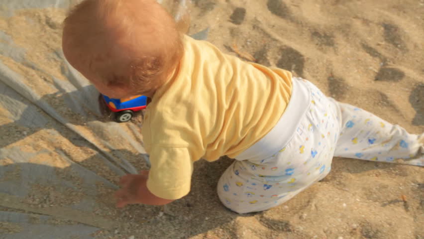 Video footage of a small baby boy in yellow baby