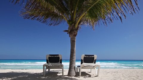 Caribbean beach with sun umbrellas and beds, Cancun, Mexico
