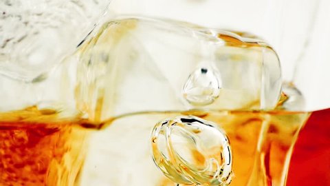 close-up of whiskey in glass with ice used for background, whisy texture
