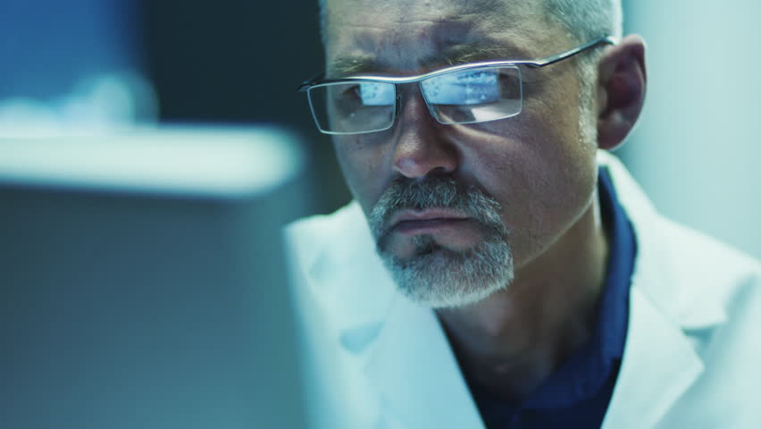 Serious and Focused Scientist Working on Computer. Shot on RED Cinema Camera in 4K (UHD).