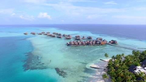 AERIAL: Luxurious over-water villas on tropical island resort