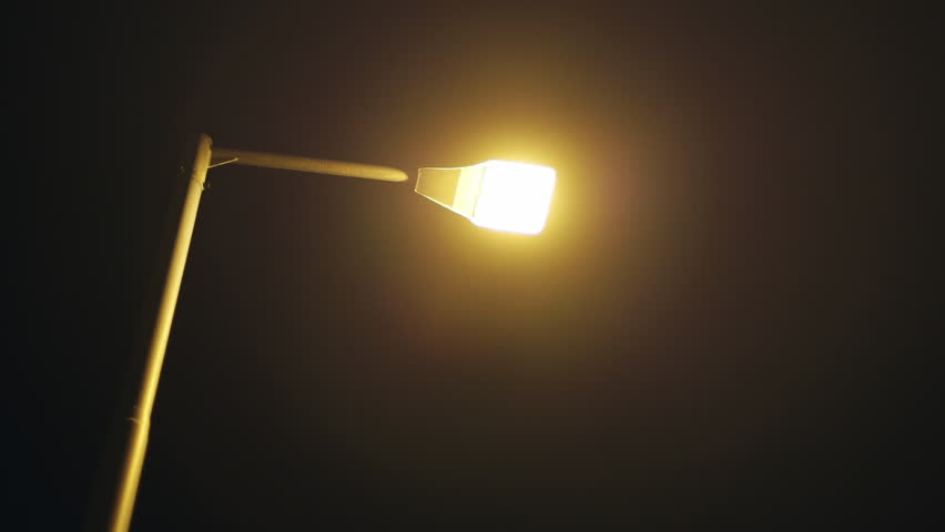 Street lamp power outage blackout.A city street lamp post suddenly goes out after a power failure. Royalty-Free Stock Footage #9433217