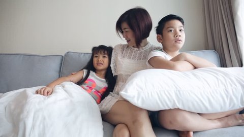 Young Asian family playing and Watching TV .