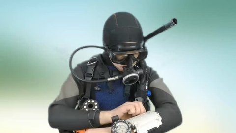 Dive instructor shows sing:GO DOWN also a available on the green screen all of diving sings from course  with full dive gear (open water diver) all background from movies separately in portfolio. 
