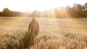 A Soldier Returning Home Finds Peace In A Wheat Field At Sunset. A soldier trying to forget the horror of war finds peace and solitude in a wheat / Barley field during sunset.