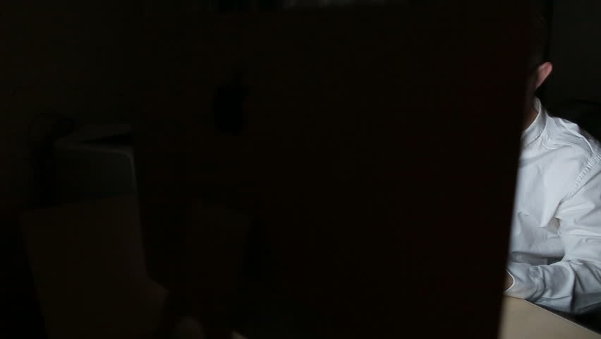 Mid adult businessman working on pc