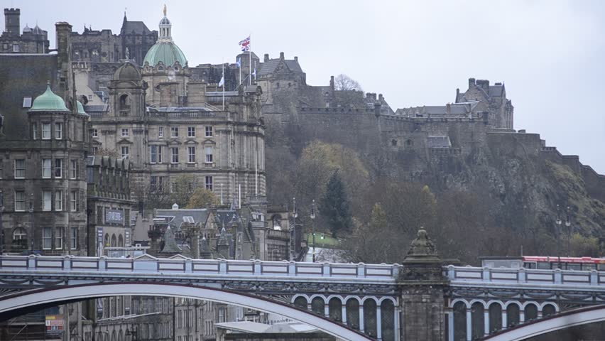 Flock of birds flying in front of North Bridge and Edinburgh Castle, Edinburgh, Scotland