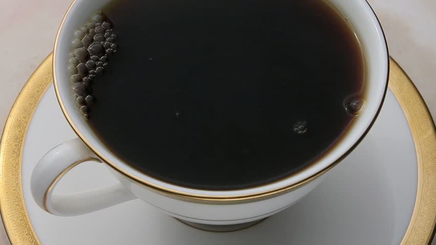 Coffee being poured into an elegant cup