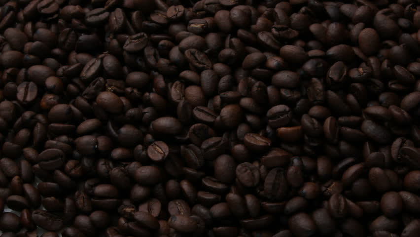 Coffee beans spilling onto marble background