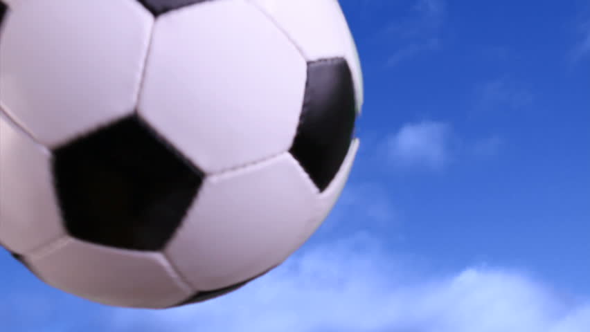 Soccer ball flying through the air. Shot on green screen