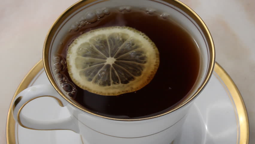 Tea with lemon being poured