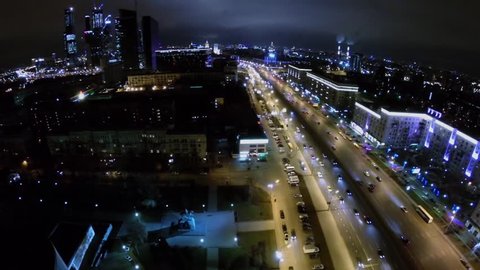 Cityscape with skyscrapers complex and Kutuzovsky highway with transport traffic at autumn evening. Aerial view